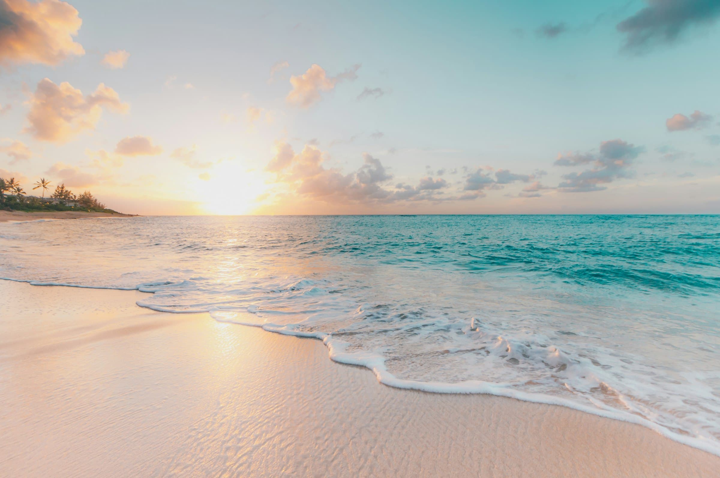 Tropical beach at sunset with gentle waves